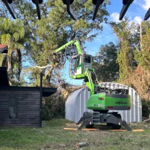 Tree care crew performing trimming work in Booneville, MS backyard